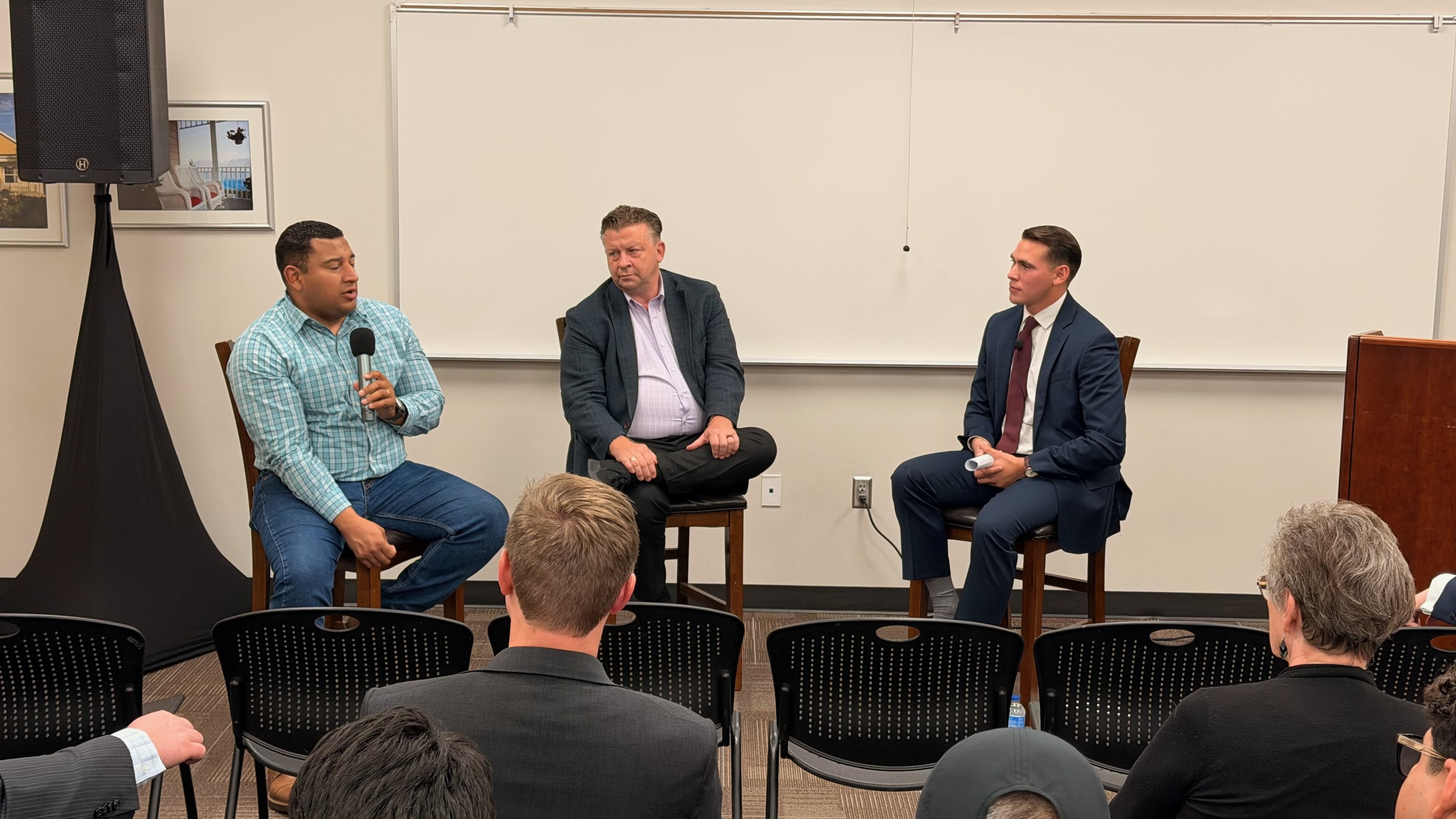 Salt Lake County Councilman Carlos Moreno speaking beside Utah State Senator Todd Weiler and Seth A. Villagomez at the Utah Emerging Leaders Forum
