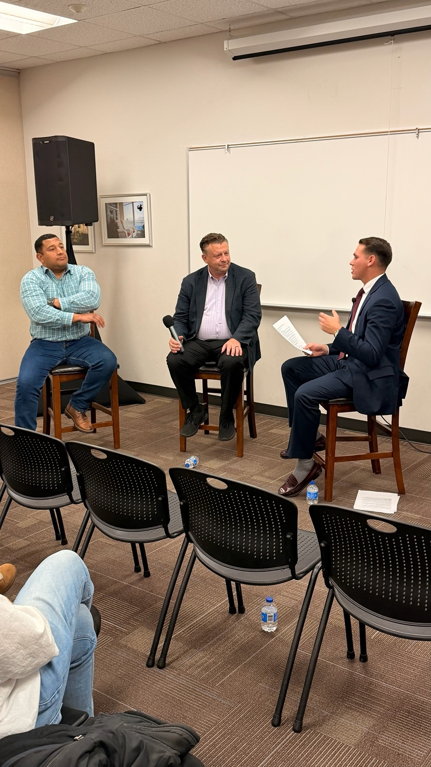Salt Lake County Councilman Carlos Moreno and Utah State Senator Todd Weiler speaking with Seth A. Villagomez before the UELF audience